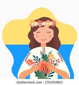 Ukrainian girl girl in the folk costume with flowers, wreath and national flag of Ukraine.Happy Independence, Constitution day
