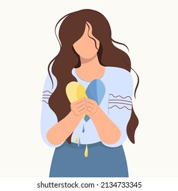 Ukrainian girl with the heart of Ukraine in her hands. Sad woman mourns. Concept of grief, pain, loss, death for banner design, landing page. Flat isolated vector design. Light background. No war.