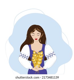 Ukrainian girl in national clothes with wheat in her hands