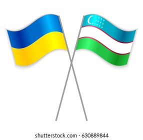 Ukrainian and Uzbek crossed flags. Ukraine combined with Uzbekistan isolated on white. Language learning, international business or travel concept.