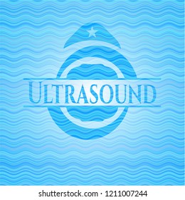 Ultrasound light blue water badge background.