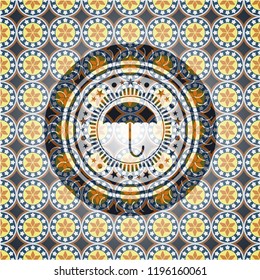 umbrella icon inside arabic badge. Arabesque decoration.