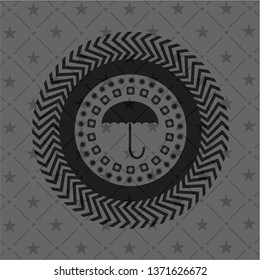 umbrella icon inside black emblem