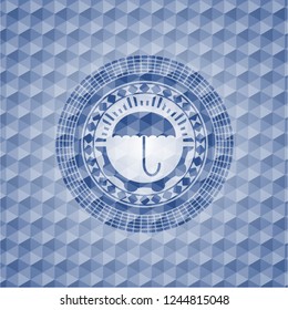 umbrella icon inside blue badge with geometric background.