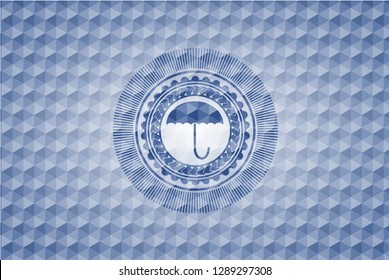 umbrella icon inside blue badge with geometric pattern.