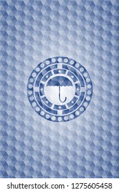 umbrella icon inside blue polygonal emblem.
