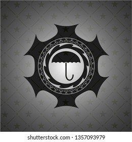 umbrella icon inside dark badge or emblem