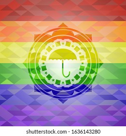 umbrella icon inside emblem on mosaic background with the colors of the LGBT flag