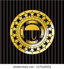 umbrella icon inside gold badge or emblem