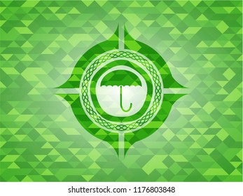 umbrella icon inside green emblem with triangle mosaic background