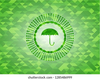 umbrella icon inside green emblem with mosaic background