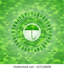 umbrella icon inside green mosaic emblem