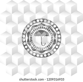 umbrella icon inside grey badge with geometric cube white background