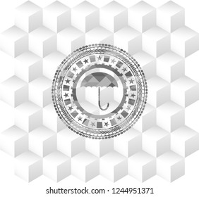 umbrella icon inside grey icon or emblem with geometric cube white background
