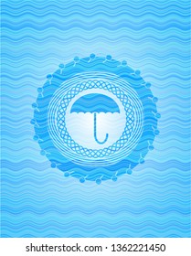 umbrella icon inside light blue water badge.