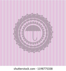 umbrella icon inside pink emblem