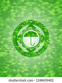 umbrella icon inside realistic green mosaic emblem