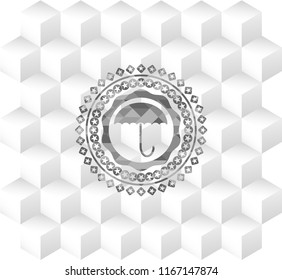 umbrella icon inside realistic grey emblem with geometric cube white background