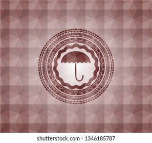 umbrella icon inside red seamless emblem with geometric background.