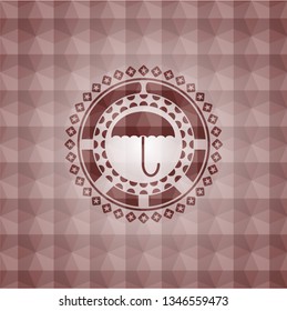 umbrella icon inside red seamless badge with geometric pattern.