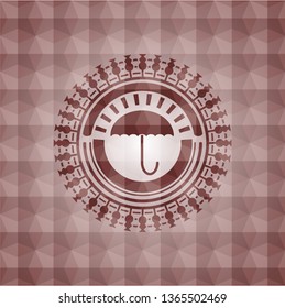 umbrella icon inside red seamless emblem with geometric pattern.
