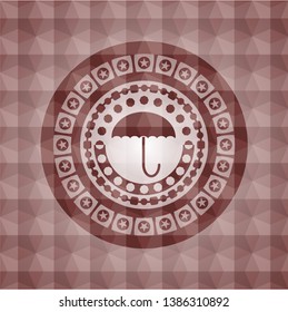 umbrella icon inside red seamless emblem with geometric background.