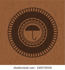 umbrella icon inside retro style wooden emblem