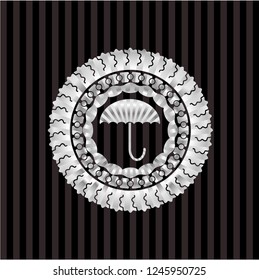 umbrella icon inside silver badge or emblem