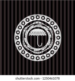 umbrella icon inside silver emblem