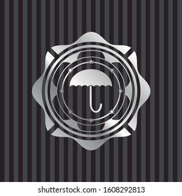 umbrella icon inside silvery badge