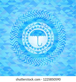 umbrella icon inside sky blue mosaic emblem