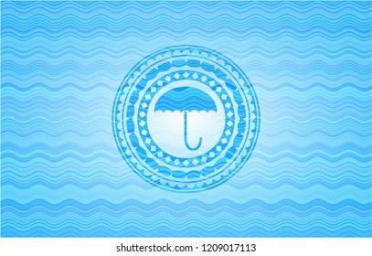 umbrella icon inside water emblem background.