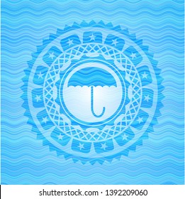 umbrella icon inside water emblem.