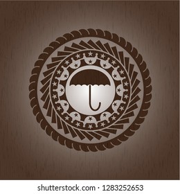 umbrella icon inside wood emblem. Retro