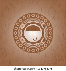 umbrella icon inside wood emblem. Retro
