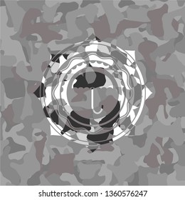 umbrella icon on grey camouflage pattern