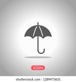 umbrella icon. Icon under spotlight. Gray background