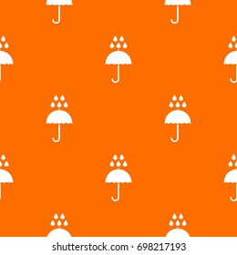 Umbrella and rain drops pattern repeat seamless in orange color for any design. Vector geometric illustration