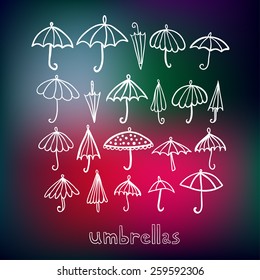 Umbrellas doodle collection on blurred background.