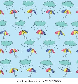 umbrellas with rain and clouds on light-blue background