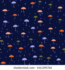 Umbrellas - seamless pattern. Small colorful umbrellas, raindrops. Dark-blue background. Texture for tissue, paper, etc.