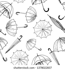 Umbrellas seamless sketch pattern. Black hand drawn umbrellas without background. Wallpaper pattern, doodle of umbrellas. Vector backdrop.