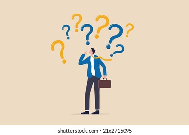 Uncertainty, confusion and decision making, choosing options or choices, answer for question or solution, problem solving, frustrated businessman thinking and make decision with many question marks. - Shutterstock ID 2162715095