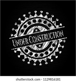 Under Construction chalkboard emblem on black board