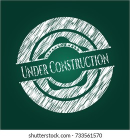 Under Construction chalkboard emblem on black board
