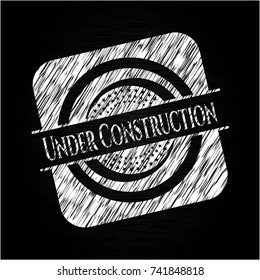 Under Construction chalkboard emblem written on a blackboard
