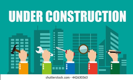 under construction concept. Hand holding tools on city background