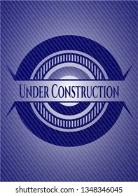 Under Construction emblem with jean background