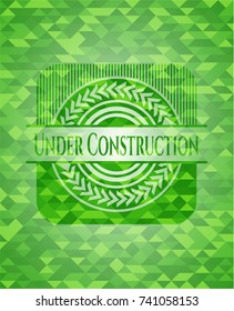 Under Construction green emblem. Mosaic background