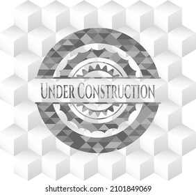Under Construction grey emblem with cube white background. 